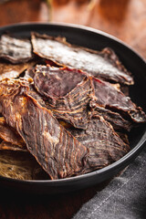 Beef jerky meat. Dried sliced meat in plate.