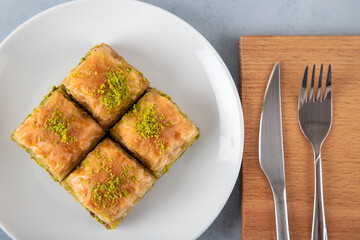 Pistachio baklava in a white plate on white background 