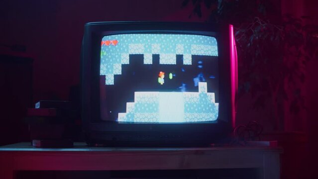 Close Up Footage of a Retro TV Set Screen with an Eight Bit Eighties Inspired Console Arcade Video Game. Quest Loading, Player Kills a Monster, Collects Hearts and a Treasure Chest, and Wins.
