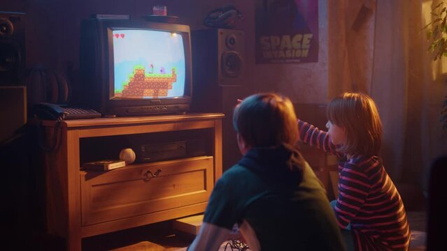 Nostalgic Childhood Concept: Young Boy and Girl Playing Old-School Arcade Video Game on a Retro TV Set at Home in a Room with Period-Correct Interior. Kids Pass the Level and Win.
