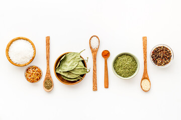 Set of colorful spices and herbs in bowls, top view