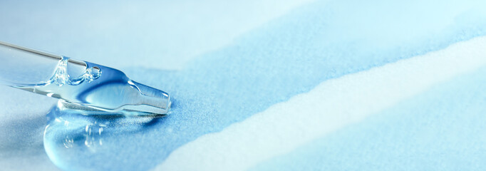 Pipette with fluid serum, oil, face gel cleaner. Cosmetics and healthcare concept closeup. Dose of...