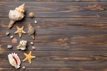 Obraz na płótnie Canvas Summer time concept Flat lay composition with beautiful starfish and sea shells on colored table, top view with copy space for text