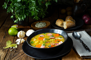 Hearty rustic pea soup with bacon and sausage