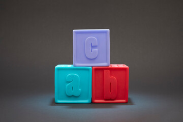 Kids alphabet block. Alphabet Block Spelling ABC stacked vertically isolated on black background.