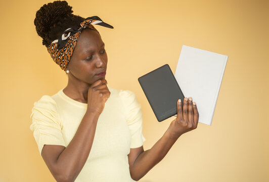 Young Woman Trying To Decide Between Printed Book Vs E-book