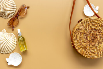 Flatlay of rattan bag withbeach accessories and seashells. Summer beach background