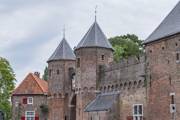 Picturesque medieval fortress city wall gate Koppelpoort and Eem River in the city of Amersfoort. Gate was built between 1380 and 1425, it combines land and water-gates. Amersfoort, the Netherlands.
