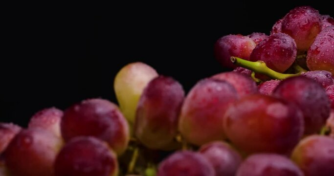 Video of red grapes on black background with 4K dolly and stop.
Shot on a black reflective background.