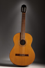 Obraz premium Classical guitar on grey background with copy space