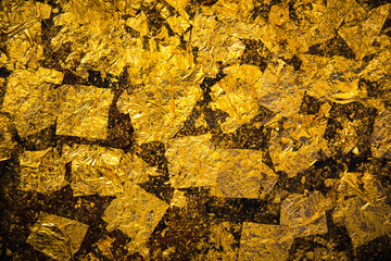 Gold background made of rough textured backdrop gold leaf.