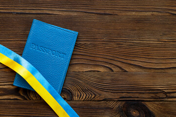 Ukrainian immigration concept - yellow and blue ribbon on passport