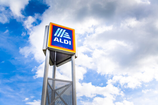 Hockenheim, Germany - June 08, 2022: Commercial sign of ALDI Store against a blue sky. ALDI is a large discount supermarket chain in Germany.