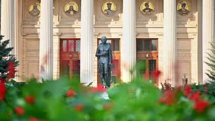Close view of Romanian Athenaeum in Bucharest, Romania. Main building, square with a statue in front of it, greenery