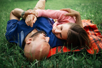 bald man hugs his beloved in meadow, concept of dating, falling in love