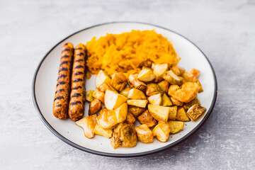 healthy vegan food, plant-based sausages with roasted potatoes and turmeric sauerkraut