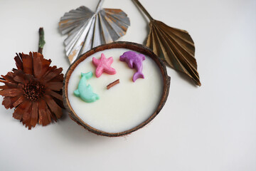 original decorative candle in a coconut. natural soy wax candle