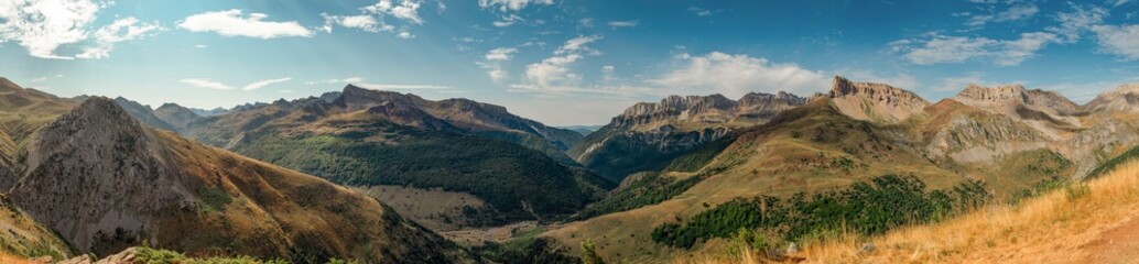 Fototapeta na wymiar Summer panoramic landscape of the forests and mountains of the Valles Occidentales Natural Park and Selva de Oza, in the Aragonese Pyrenees, in the province of Huesca, from the Acherito ravine