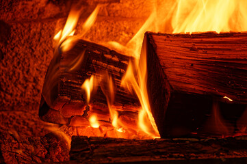Fire is burning brightly through wood in a fire place