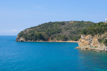 summer view of the island coast landscape among clear scenic blue sea