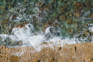 top view of water flowing over rocks, fresh summer wave natural background