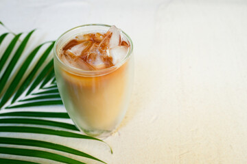 glass of milk coffee on Sand