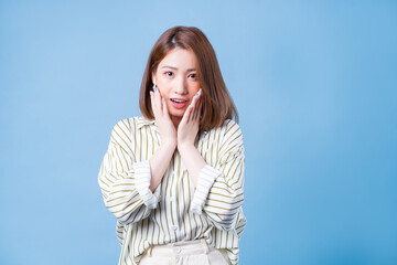 Image of young Asian girl posing on blue background