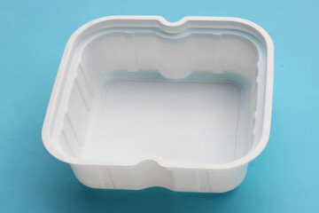 Plastic food packaging on blue background.