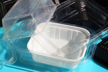 Obraz premium Plastic food packaging on blue background.