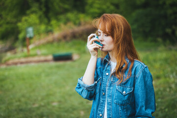  Young girl using asthma inhaler to prevent an asthma attack. Pharmaceutical product to prevent and treat asthma.