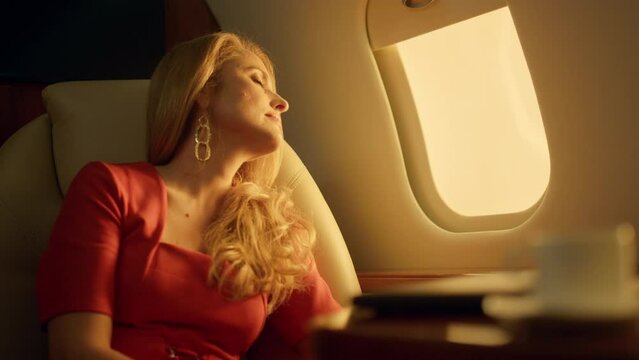 Aircraft passenger travel first class closeup. Tired beautiful blonde dreaming