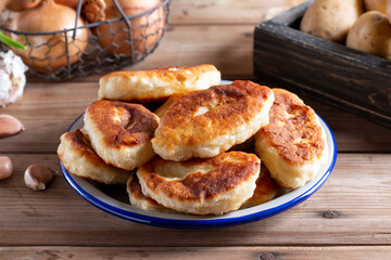 Traditional Russian pies with potatoes. Russian pirozhki, homemade baked patties.