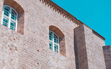 Fototapeta na wymiar Stone old european building, windows, dominican architecture style