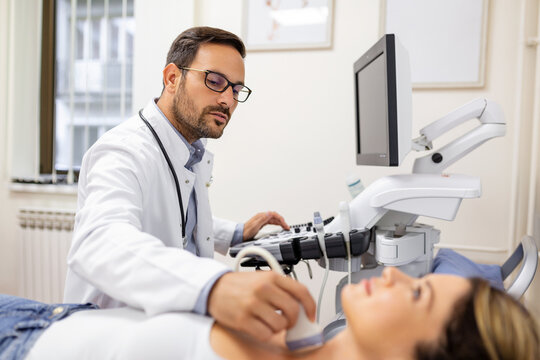 Woman patient receives thyroid diagnostics. Treatment of thyrotoxicosis, and hypothyroidism. Ultrasound diagnostics of the endocrine system and thyroid