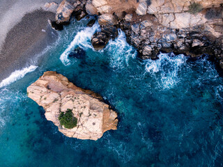 Aerial shot of a beach with rocks
