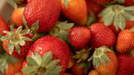 First summer harvest of strawberries. Fresh ripe strawberries background.