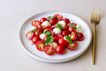 Salad with mozzarella, tomatoes, nuts and basil. Healthy eating. Vegetarian food. Diet.