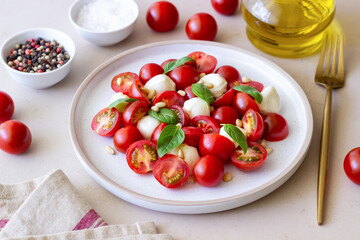 Salad with mozzarella, tomatoes, nuts and basil. Healthy eating. Vegetarian food. Diet.