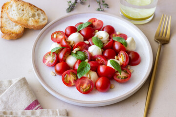 Salad with mozzarella, tomatoes, nuts and basil. Healthy eating. Vegetarian food. Diet.