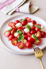 Salad with mozzarella, tomatoes, nuts and basil. Healthy eating. Vegetarian food. Diet.