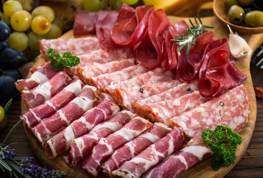 Cold cuts - prosciutto, salami, ham, cheese on the cutting board