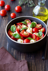 Salad with mozzarella, tomatoes, nuts and basil. Healthy eating. Vegetarian food. Diet.