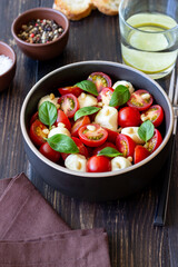 Salad with mozzarella, tomatoes, nuts and basil. Healthy eating. Vegetarian food. Diet.
