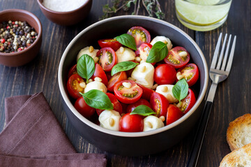 Salad with mozzarella, tomatoes, nuts and basil. Healthy eating. Vegetarian food. Diet.