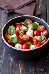 Salad with mozzarella, tomatoes, nuts and basil. Healthy eating. Vegetarian food. Diet.
