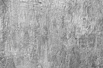 Gray background of decorative plaster with abstract spots. Unusual silver wall texture with beautiful patterns, creative surface background. Dressing coating for building cladding.