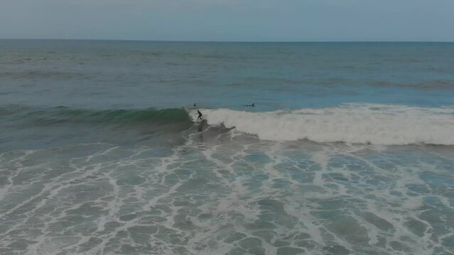 Drone shot of a Surfer surfing the famous Coxos surf spot in Ericeira, Portugal