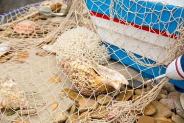 fishing net, sea pebbles and shells close-up.