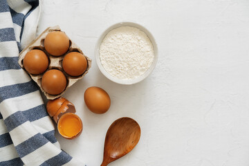 Preparation for baking. Eggs and flour on white background