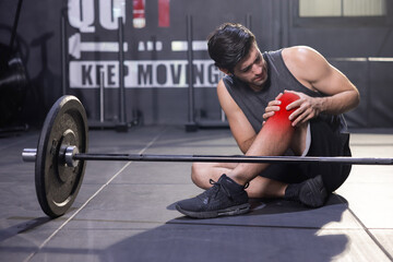 Caucasian Man Grab His Knee With Pain After Get Injured From Weight Lifting